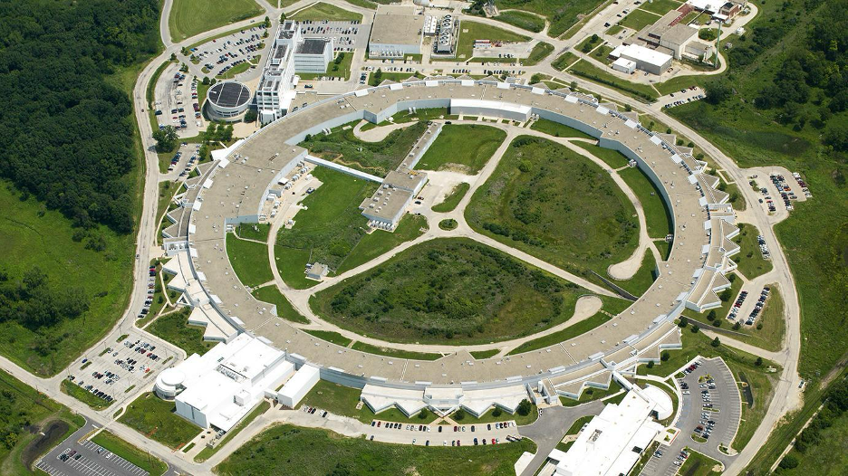 An aerial photo of Argonne National Laboratory's circular research campus surrounded by forest